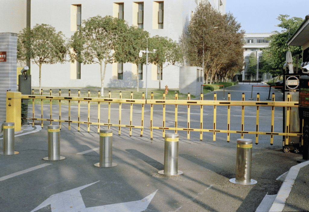Yellow barrier arm gates with bollards
