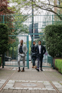 Three men walking through a commercial gate